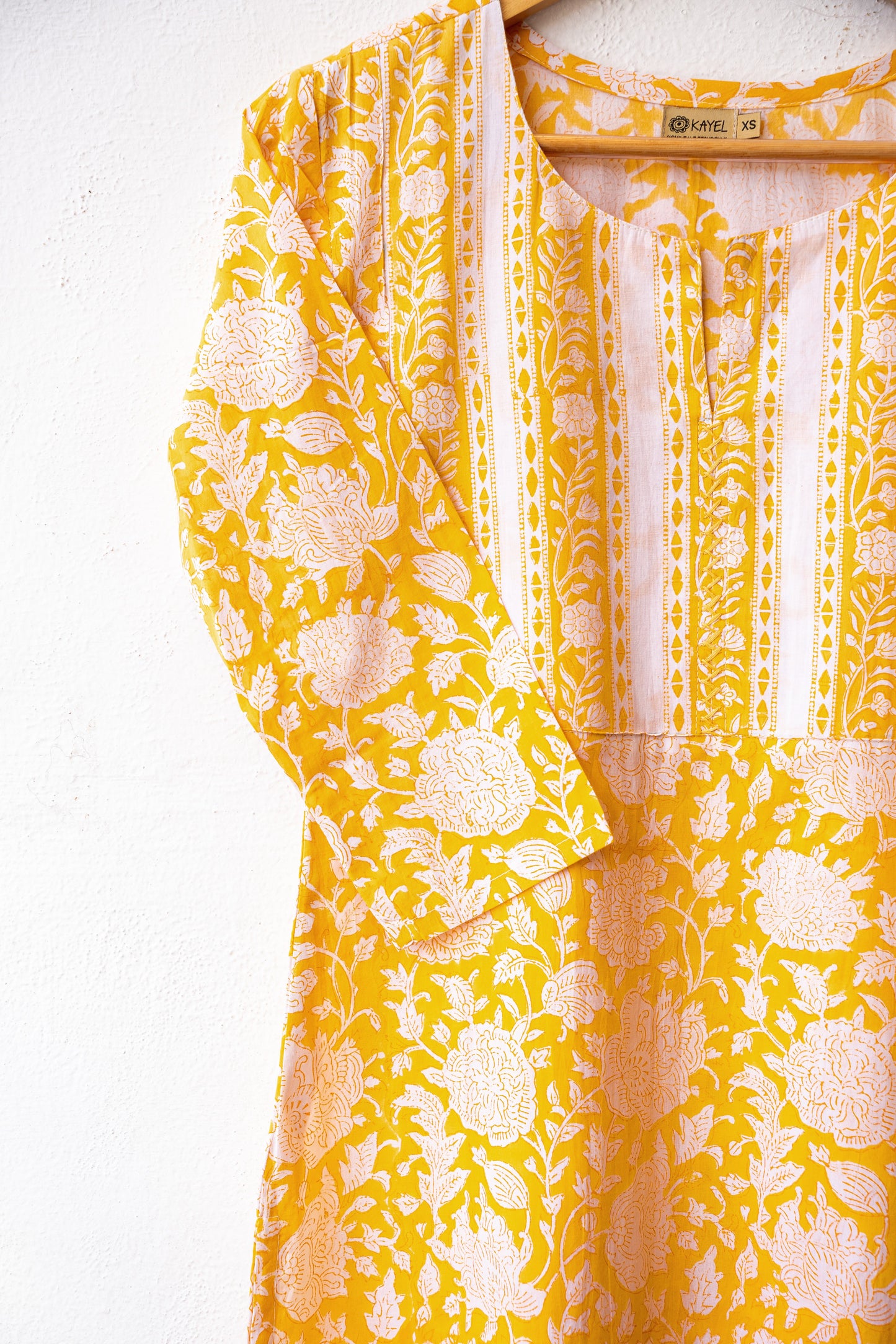Block printed kurta with vertical stripes yoke + hand embroidery.